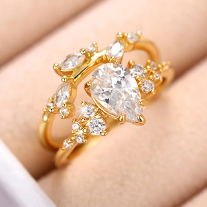 Elegant gold pear-cut gemstone ring set with sparkling crown-shaped cluster design