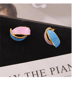 Detail of vintage geometric leaf earrings with pink and blue enamel and gold finish