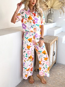 Detail of floral bohemian two-piece set with short sleeve shirt and wide leg trousers