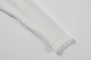 Detail of white hollow knit texture and breathable mesh fabric on sleeve cuffs