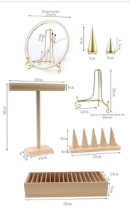 Detailed view of wood and gold metal jewelry display set with dimension annotations