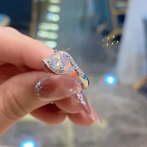 Close-up of sparkling six-claw round cubic zirconia ring with split pave band