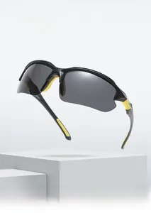 Detail of sports sunglasses with black and yellow frame and streamlined gray lenses