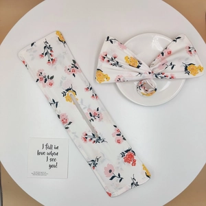 Floral print hair bun maker and bow scrunchie set in white fabric with petal patterns
