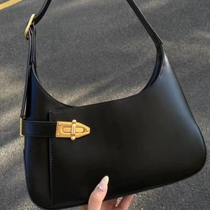 Minimalist black leather crescent hunderarm bag with vintage golden metal buckle