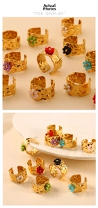 Detailed macro view of colorful beaded flower petals on gold hammered texture open rings