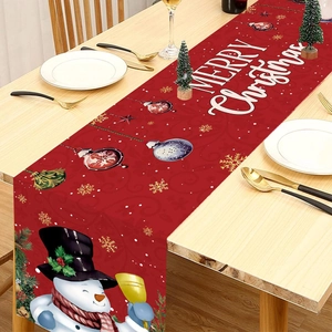 Christmas snowman table runner with Merry Christmas lettering on a wooden dining table