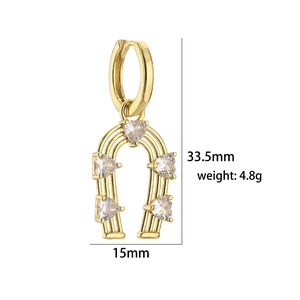 Macro view of gold horseshoe earrings with heart cubic zirconia, 33.5mm height