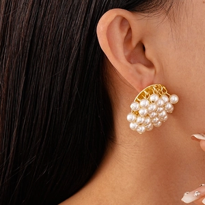 Detailed close-up of French vintage cluster pearl earrings on a model showing elegant texture