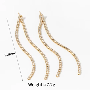 Detail view of 9.8cm gold tassel earrings with sparkling zircon wave design