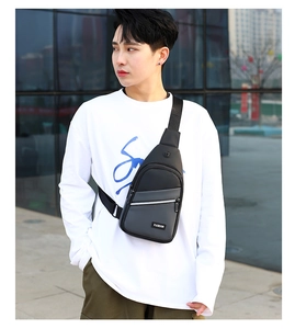 Detail of multi-pocket nylon chest bag with earphone port and front fashion label