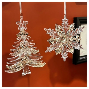 Macro detail of transparent acrylic Christmas tree and snowflake charms with gold sequins