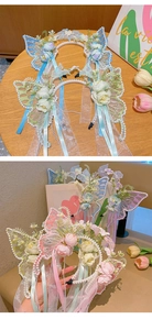 Detailed view of lace butterfly wings with artificial flowers and dangling pearls on headband