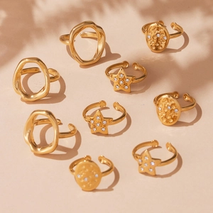 Gold hollow geometric stainless steel open ring set with star and textured ring designs
