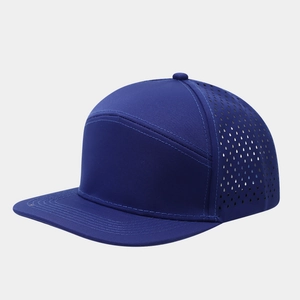 Macro detail of laser-cut ventilation holes and stitching on navy flat brim baseball cap