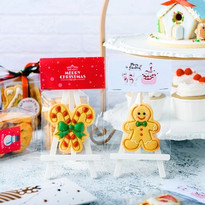 Christmas gingerbread man and candy cane cookies in festive red and white packaging