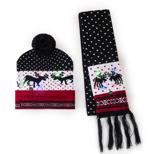 Detail of LED glowing Christmas knitted hat and scarf set with reindeer pattern