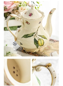 Detail of vintage ceramic teapot handle with gold trim and internal filter holes