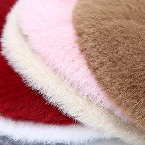 Detailed macro view showing the soft, fluffy faux fur texture of beret hats in various colors