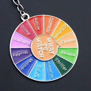 Detailed macro view of the colorful What to Watch rotating wheel keychain for movie choices