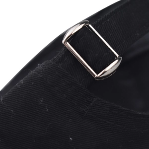 Detail of adjustable metal buckle and black cotton twill strap on baseball cap back