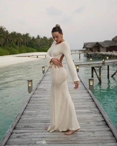 Close-up of cream white backless knitted maxi dress featuring tie-back detail and long sleeves