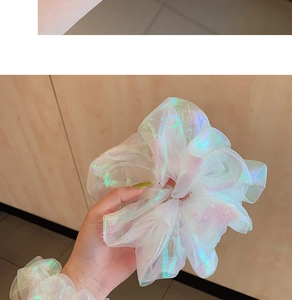 Close-up of holographic organza scrunchie with iridescent laser shine and soft mesh texture