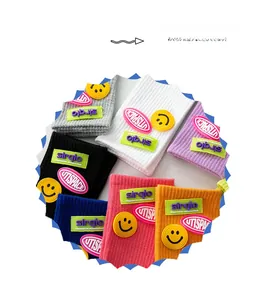Colorful ribbed crew socks featuring embroidered smiley faces and trendy street style labels