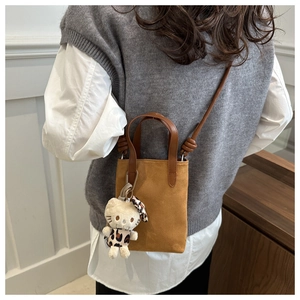 Brown suede crossbody phone bag featuring a trendy leopard print plush kitten charm