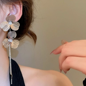Detail of flower tassel earrings with zircon petals and cascading rhinestone chains