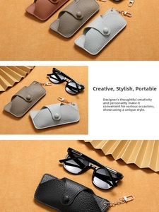 Macro shot of lychee grain leather glasses cases with metal chain and snap button