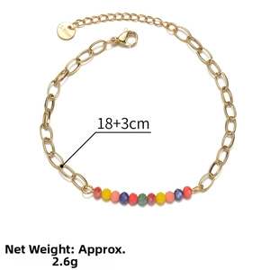 Macro detail of 14k gold-plated stainless steel chain with colorful faceted beads