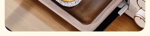 Close-up of food-grade aluminum foil bowl inside a toaster oven on a wooden surface