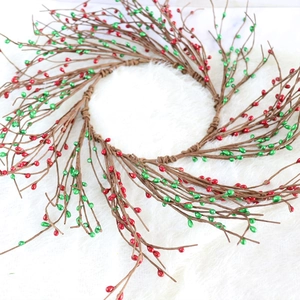 Christmas wreath with red and green berries on a brown twig base for holiday door decor