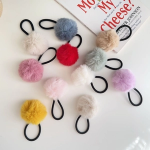 Close-up of colorful plush pom pom hair ties set with high elastic black bands