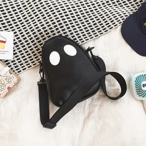 Overhead view of a cute ghost-shaped PU leather crossbody bag with soft eyes and strap