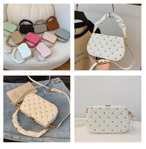 Detail of quilted square handbag with flower rivets and ruffled cloud top handle