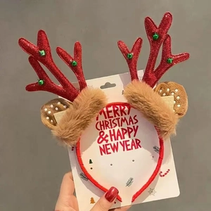 Close-up of red glitter reindeer antlers with green bells and festive faux fur detail