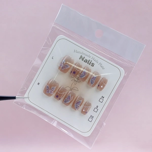 Cat eye press-on nails set with dreamy purple butterfly pattern and nude pink finish