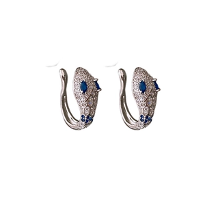 Silver snake-shaped clip-on earrings with blue and white zircon stones on white background