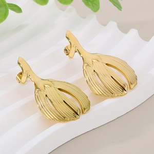 Elegant gold leaf earrings with vertical texture on a minimalist white display