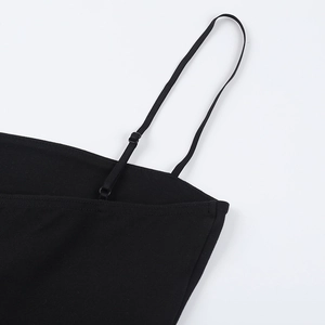 Close-up of adjustable spaghetti strap and detailed stitching on a black mini dress