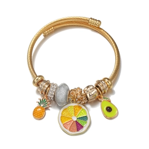 Detail of gold cable wire bracelet featuring pineapple, orange and avocado charms