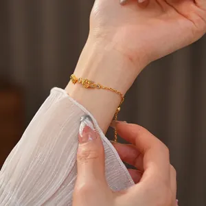 Bracelet rose élégant plaqué or 18 carats avec zircons porté au poignet d'une femme