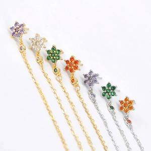 Macro shot of s925 silver needle flower stud earrings with long chain fringe and zircon stones