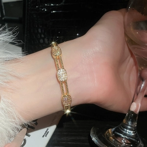 Detail of 18k gold plated bracelet with pave zircon links worn on wrist