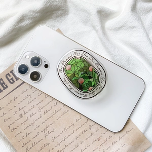 Floral stained glass style phone socket grip with green leaves on a white smartphone