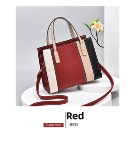 Detail shot of tricolor PU leather handbag showing gold logo and stitching quality