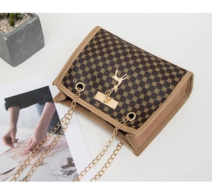 Detailed view of women's beige rhomboid bag featuring a golden deer charm and metal chain strap