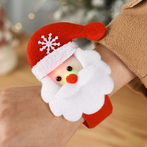 Glow-in-the-dark Santa Claus plush snap bracelet on wrist with festive LED lights